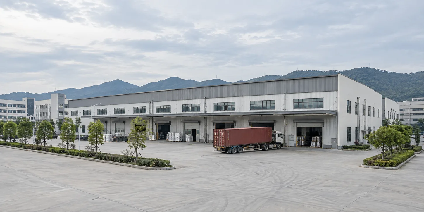 Aerial view of the Tansox packaging factory exterior in Quanzhou, showing loading docks and a truck being loaded for shipment
